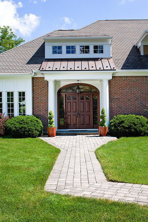 Photo of a traditional entryway in New York with slate floors, a double front door and a medium wood front door.