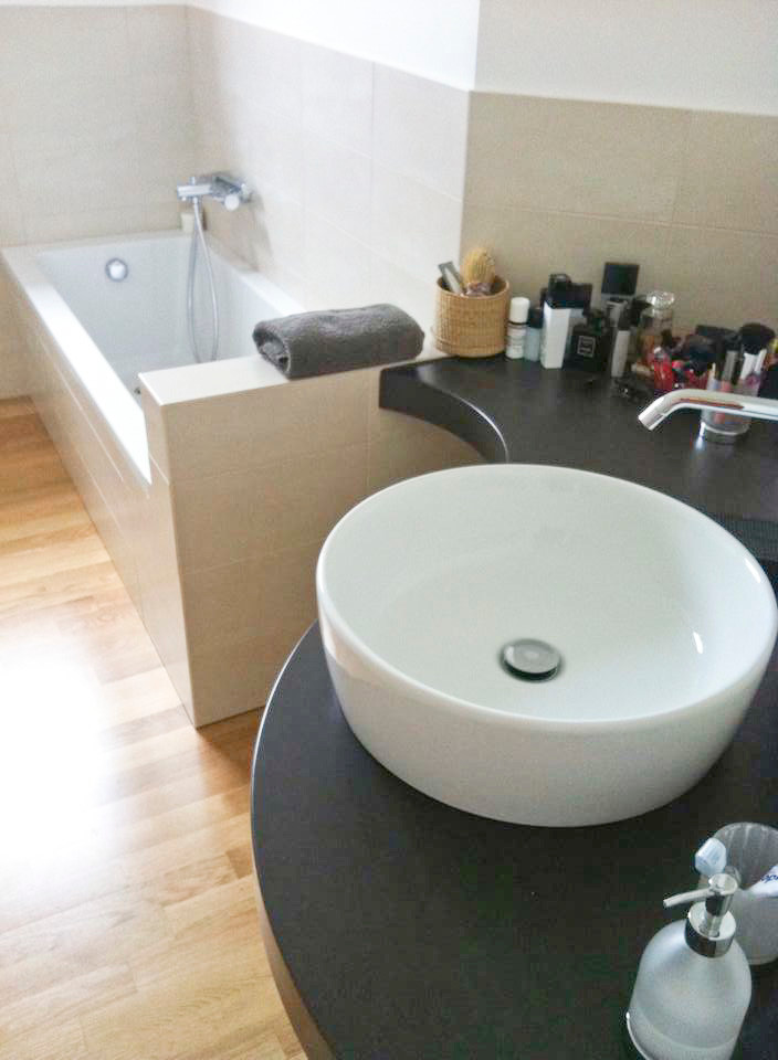 Inspiration for a small modern master black tile and ceramic tile light wood floor corner bathtub remodel in Milan with a bidet and beige walls