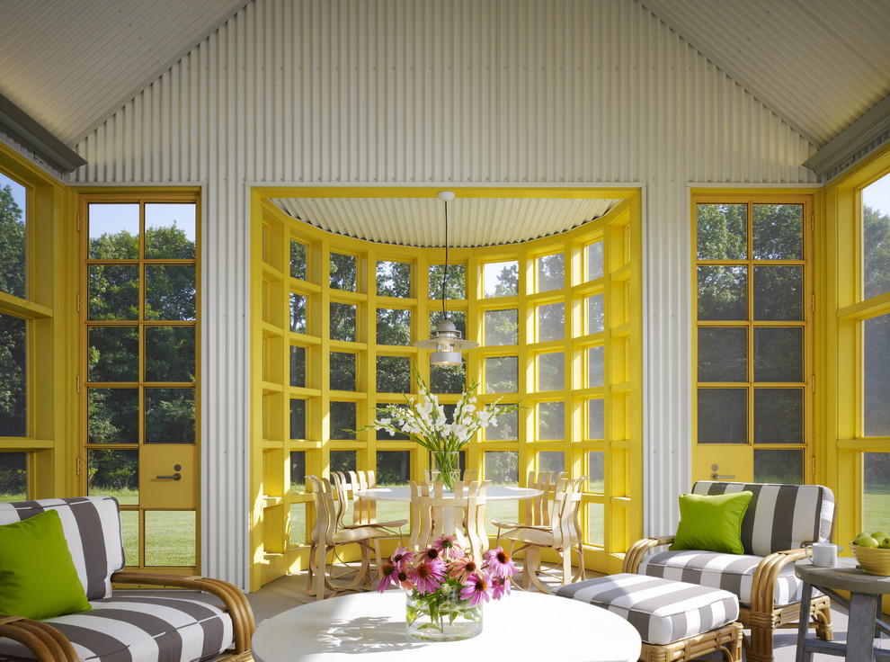 This is an example of a large traditional sunroom in Chicago with a standard ceiling and grey floor.