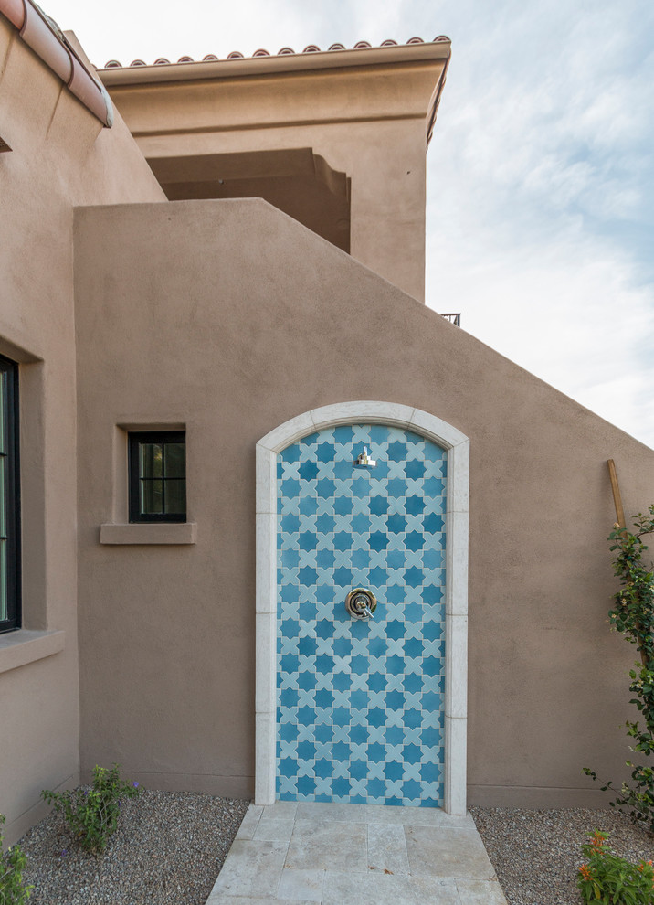 Expansive transitional two-storey stucco beige house exterior in Phoenix with a tile roof.