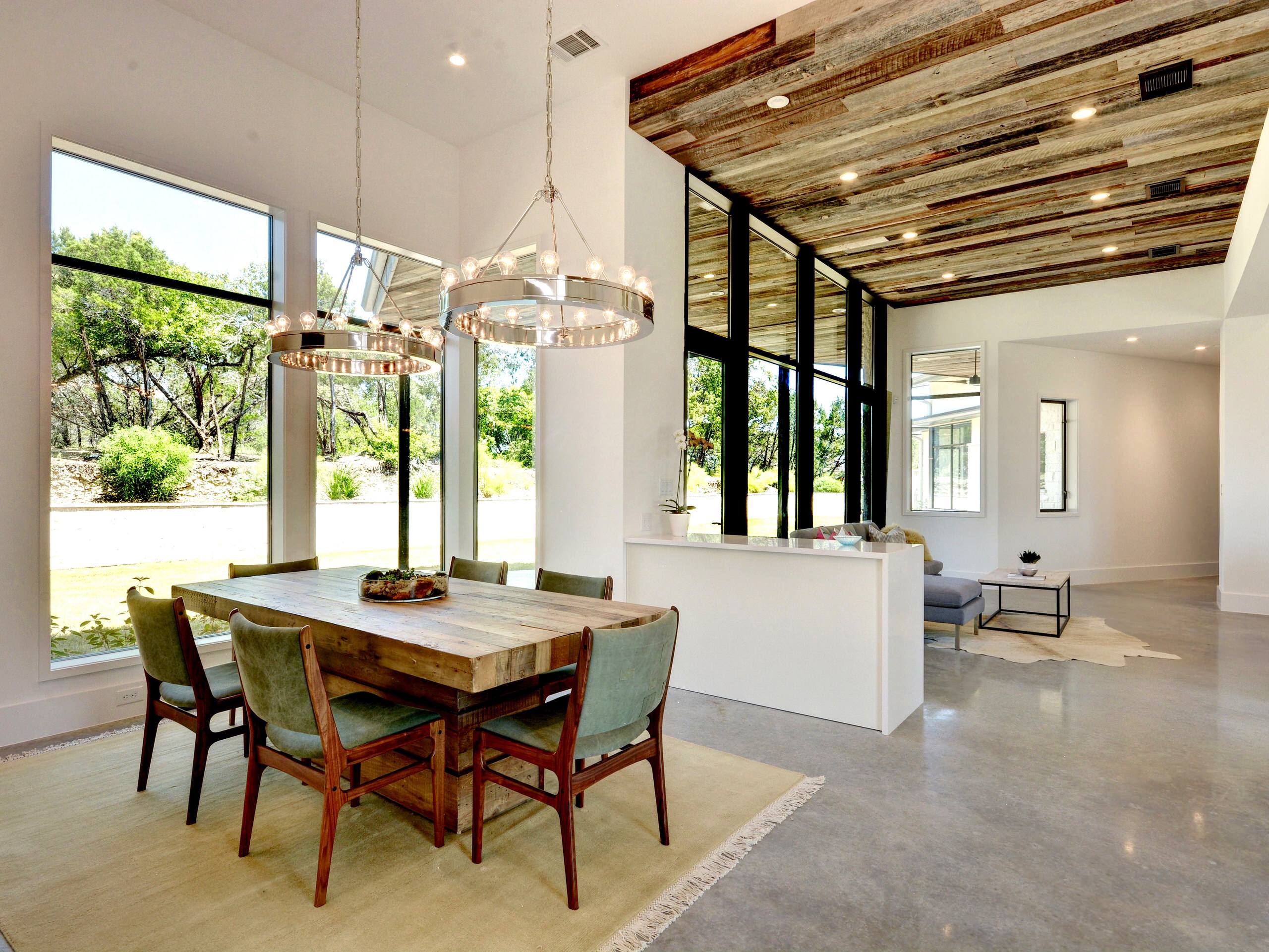 Great room - mid-sized eclectic concrete floor great room idea in Austin with white walls and no fireplace