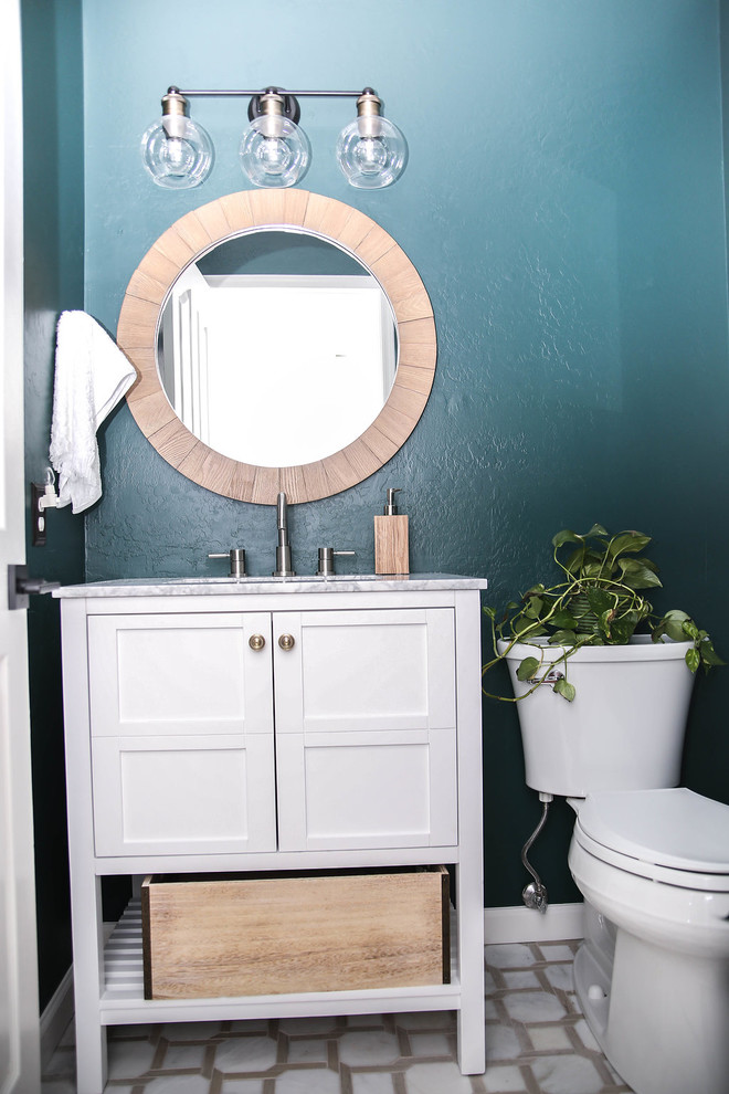 Photo of a small midcentury powder room in Phoenix with furniture-like cabinets, white cabinets, a one-piece toilet, green walls, ceramic floors, a console sink, marble benchtops, white floor and white benchtops.
