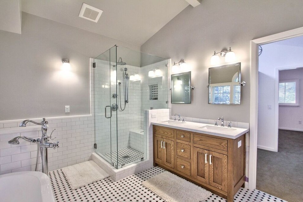 Design ideas for a mid-sized transitional master bathroom in Los Angeles with furniture-like cabinets, blue cabinets, a freestanding tub, a corner shower, white tile, grey walls, a wall-mount sink, multi-coloured floor, a hinged shower door and white benchtops.