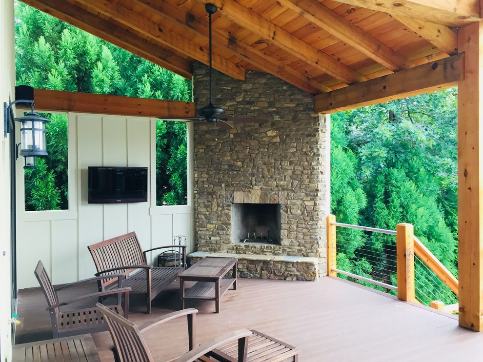 Mid-sized country backyard deck in Atlanta with a fire feature and a roof extension.