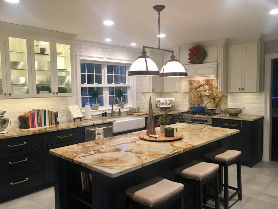 Inspiration for a mid-sized kitchen remodel in Atlanta with a farmhouse sink, granite countertops, white backsplash, ceramic backsplash, stainless steel appliances and an island