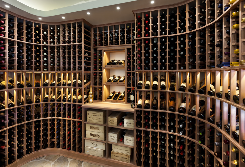 This is an example of a contemporary wine cellar in Detroit with storage racks and brown floor.