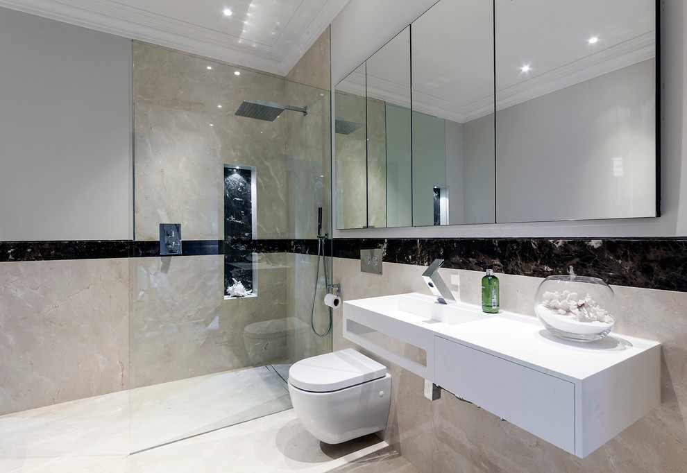 Design ideas for a mid-sized contemporary master bathroom in London with an open shower, a wall-mount toilet, multi-coloured tile, porcelain tile, white walls, porcelain floors, an integrated sink, solid surface benchtops, beige floor, an open shower and white benchtops.