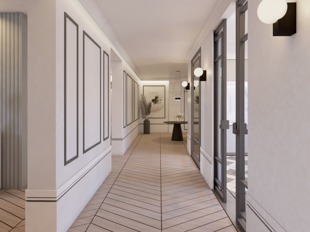 На фото: большой коридор в стиле неоклассика (современная классика) с белыми стенами, паркетным полом среднего тона и панелями на стенах