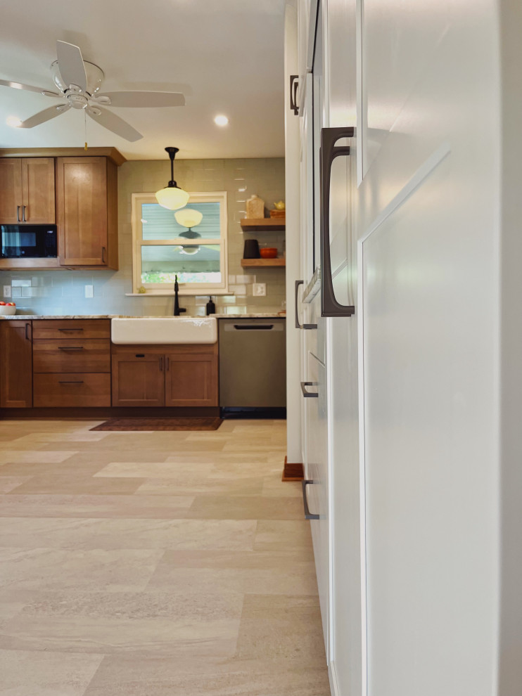 Inspiration for a mid-sized transitional l-shaped vinyl floor and beige floor eat-in kitchen remodel with a farmhouse sink, shaker cabinets, medium tone wood cabinets, quartzite countertops, green backsplash, ceramic backsplash, stainless steel appliances, no island and beige countertops