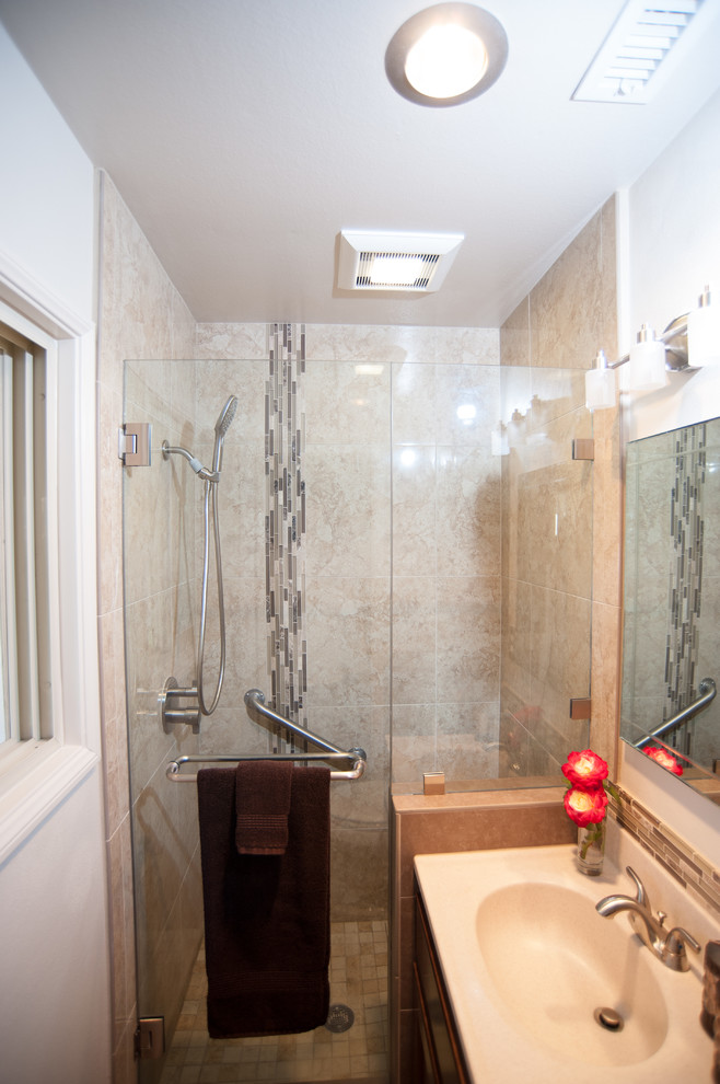 Inspiration for a mid-sized traditional master bathroom in San Diego with recessed-panel cabinets, dark wood cabinets, an alcove shower, a two-piece toilet, beige tile, glass tile, white walls, travertine floors, an integrated sink and onyx benchtops.