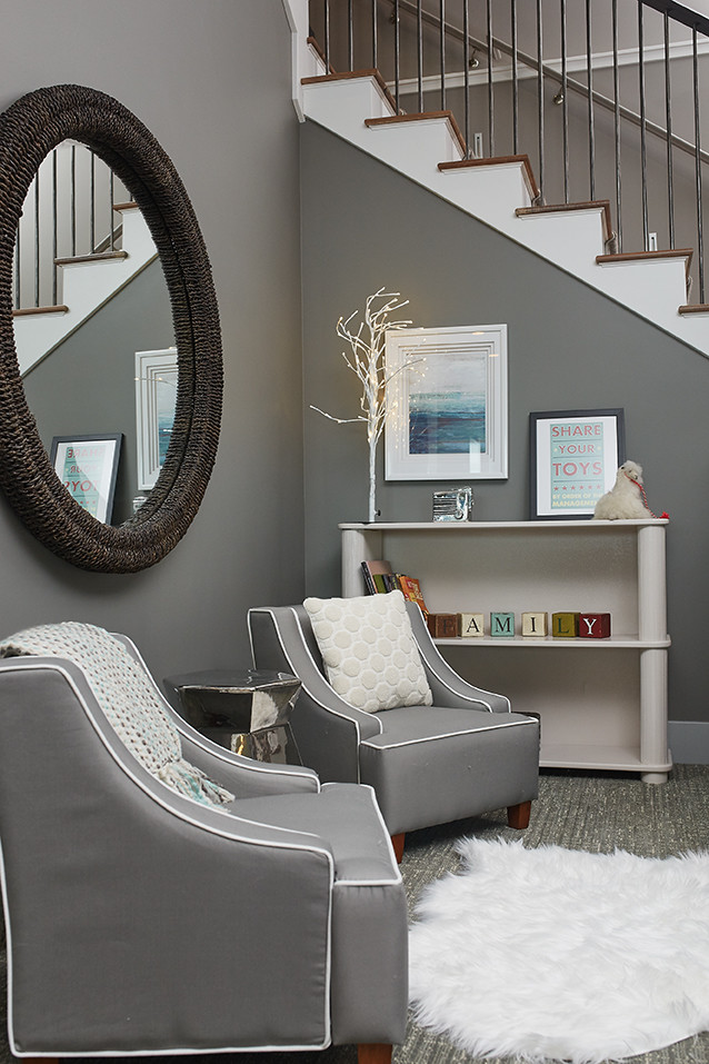Photo of a small contemporary gender-neutral kids' playroom in Grand Rapids with grey walls, carpet and grey floor.