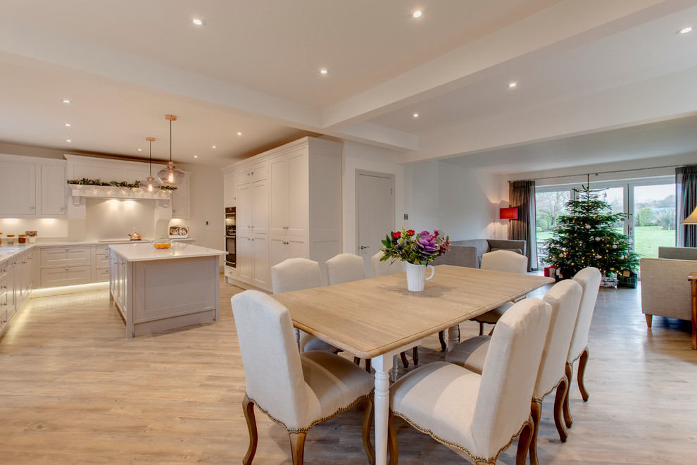 Inspiration for a large transitional open plan dining in Other with white walls, light hardwood floors and no fireplace.
