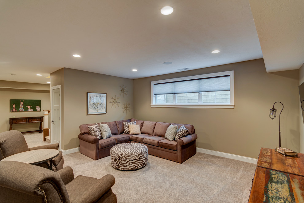 This is an example of a mid-sized arts and crafts enclosed family room in Indianapolis with beige walls, carpet, no fireplace, a wall-mounted tv and beige floor.