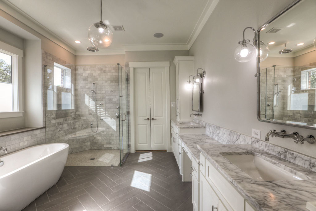 Design ideas for a large traditional master bathroom in Houston with a freestanding tub, a corner shower, white tile, marble, beige walls, laminate floors, grey floor and a hinged shower door.