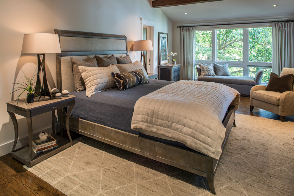 Inspiration for a mid-sized transitional master bedroom in Other with white walls, dark hardwood floors, a standard fireplace, a stone fireplace surround and brown floor.