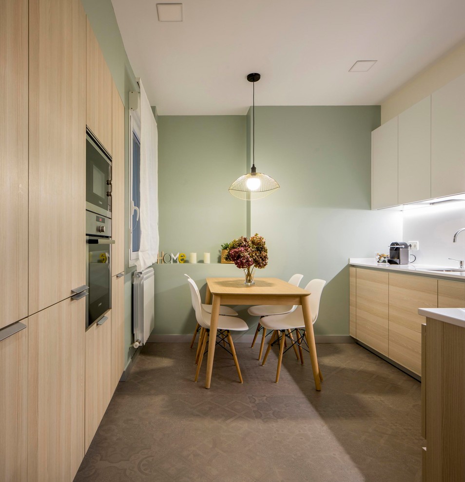 Photo of a contemporary eat-in kitchen in Other with an undermount sink, flat-panel cabinets, light wood cabinets, white splashback, white benchtop, no island and grey floor.