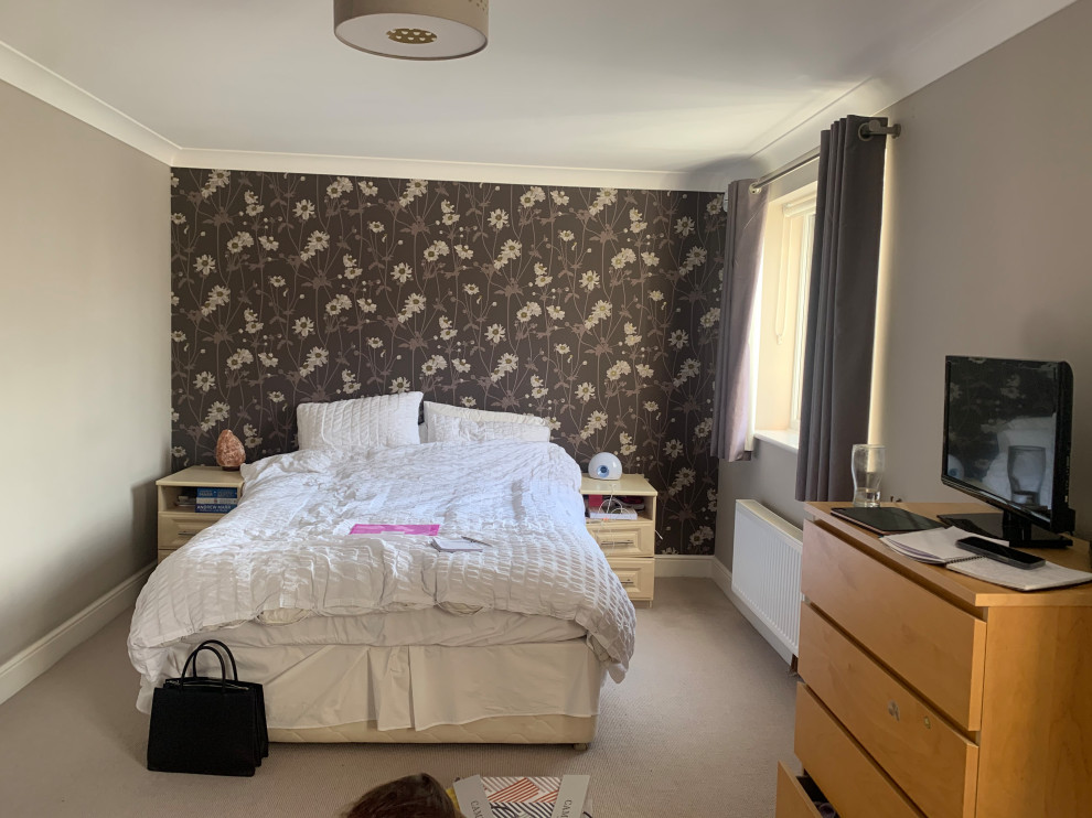 Mid-sized trendy master carpeted, gray floor and wallpaper bedroom photo in Hertfordshire with gray walls