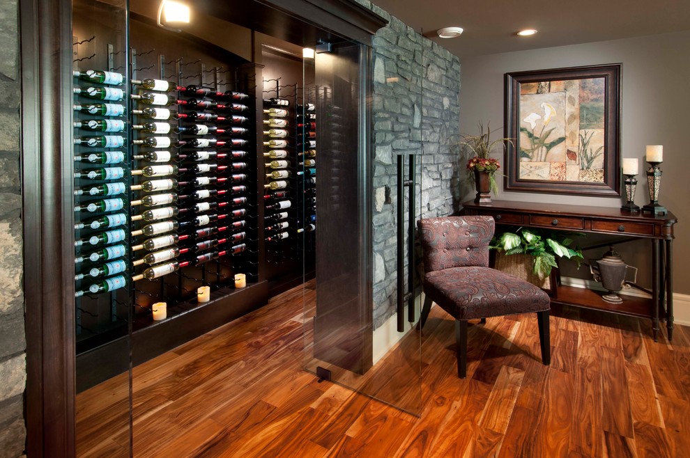 Mid-sized traditional wine cellar in Calgary with display racks, medium hardwood floors and orange floor.