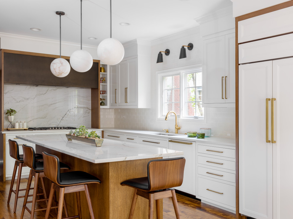 Design ideas for a mid-sized scandinavian l-shaped kitchen in Chicago with an undermount sink, recessed-panel cabinets, white cabinets, quartzite benchtops, white splashback, panelled appliances, medium hardwood floors, with island and white benchtop.