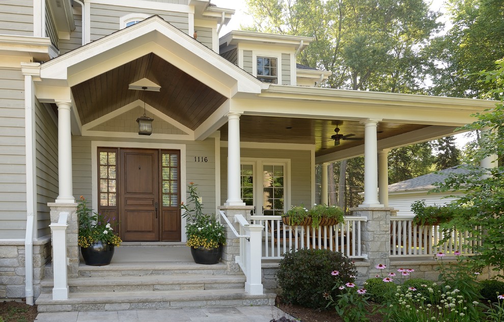 Traditional entryway in Chicago with a single front door and a dark wood front door.