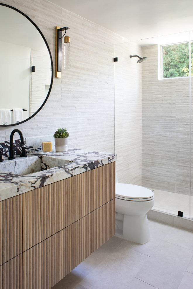 This is an example of a modern bathroom in Los Angeles with light wood cabinets, an alcove shower, beige tile, an integrated sink, beige floor, multi-coloured benchtops, a single vanity and a floating vanity.