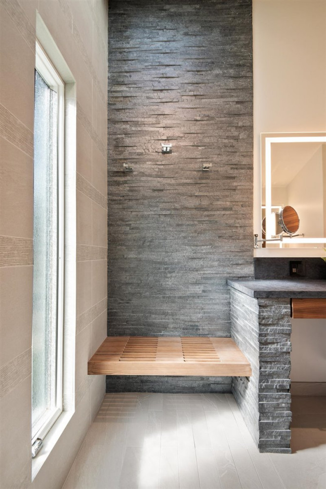 Photo of a large midcentury master bathroom in San Francisco with flat-panel cabinets, medium wood cabinets, a curbless shower, a one-piece toilet, gray tile, ceramic tile, wood-look tile, solid surface benchtops, an open shower, black benchtops, a floating vanity and vaulted.