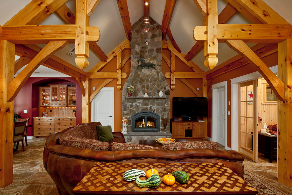 Traditional living room in Portland Maine with orange walls, a standard fireplace and a stone fireplace surround.
