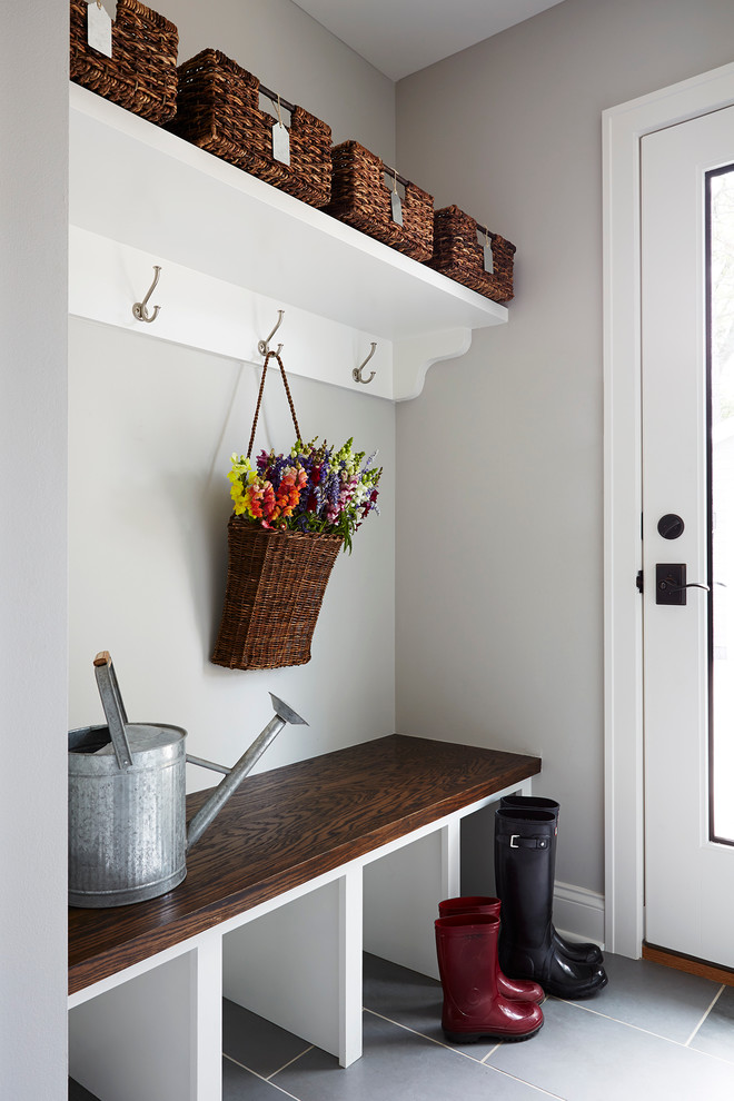 Inspiration for a small transitional mudroom in Minneapolis with grey walls and slate floors.