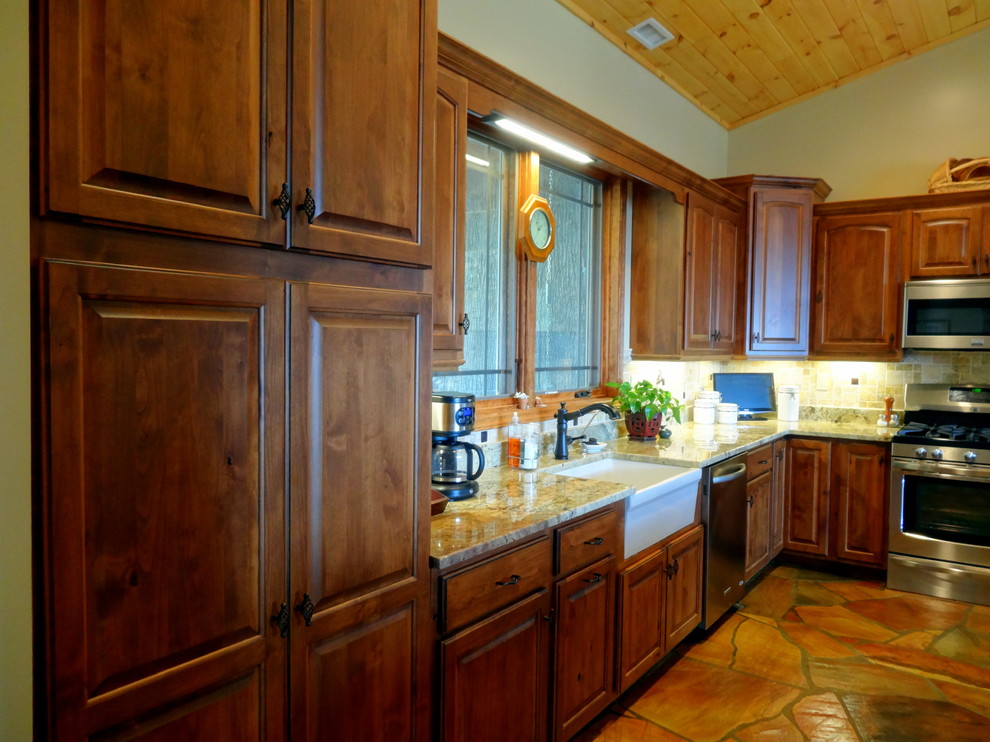 Open concept kitchen - mid-sized rustic l-shaped slate floor open concept kitchen idea in Charlotte with a farmhouse sink, raised-panel cabinets, dark wood cabinets, granite countertops, multicolored backsplash, ceramic backsplash, stainless steel appliances and a peninsula