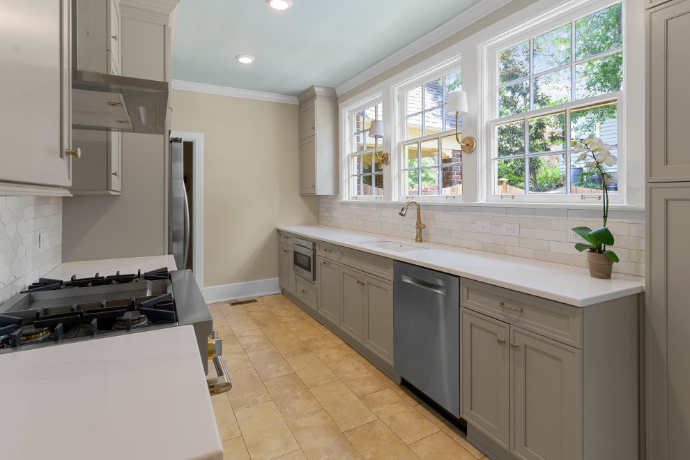Inspiration for a small transitional galley porcelain tile and beige floor enclosed kitchen remodel in Birmingham with a single-bowl sink, recessed-panel cabinets, gray cabinets, quartz countertops, white backsplash, ceramic backsplash, stainless steel appliances, no island and white countertops