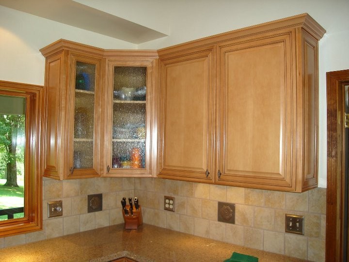 Kitchen - mid-sized kitchen idea with raised-panel cabinets, medium tone wood cabinets, granite countertops, beige backsplash and ceramic backsplash