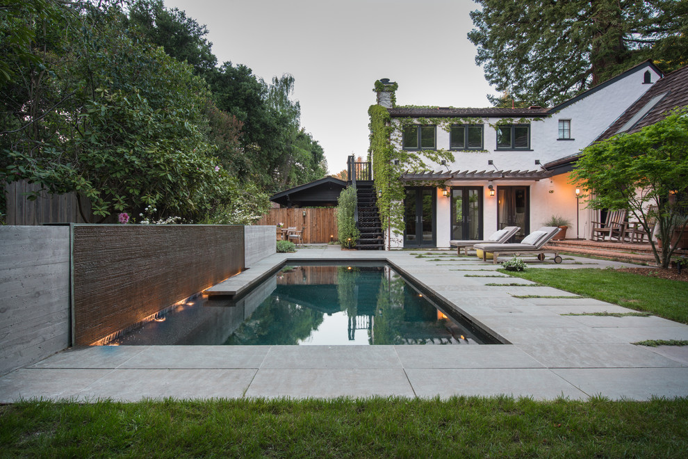 Small traditional backyard rectangular lap pool in San Francisco with a water feature and concrete pavers.