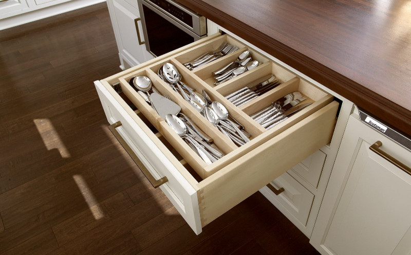 Inspiration for a large l-shaped dark wood floor eat-in kitchen remodel in Miami with a farmhouse sink, beaded inset cabinets, white cabinets, solid surface countertops, beige backsplash, stainless steel appliances and an island