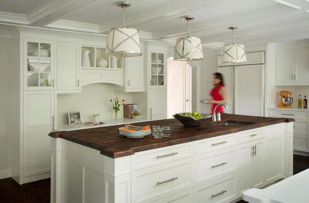 This is an example of an expansive transitional u-shaped separate kitchen in Boston with a farmhouse sink, recessed-panel cabinets, white cabinets, quartz benchtops, white splashback, ceramic splashback, panelled appliances, dark hardwood floors and with island.