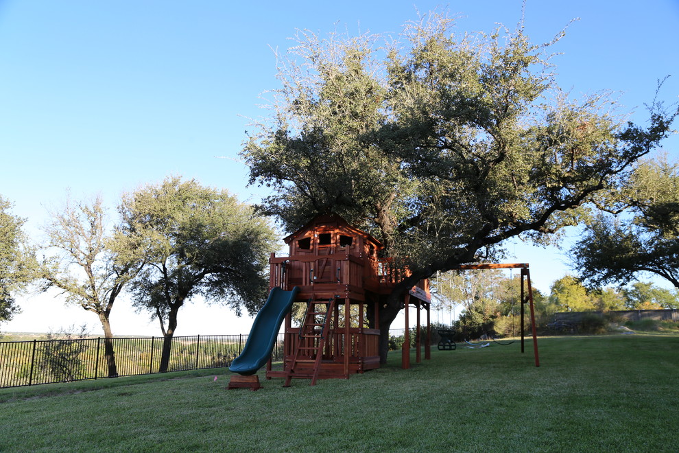 Large classic back fully shaded garden for summer in Dallas with a climbing frame and an outdoor sport court.