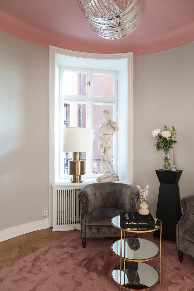 This is an example of a medium sized bohemian living room in Stockholm with grey walls.