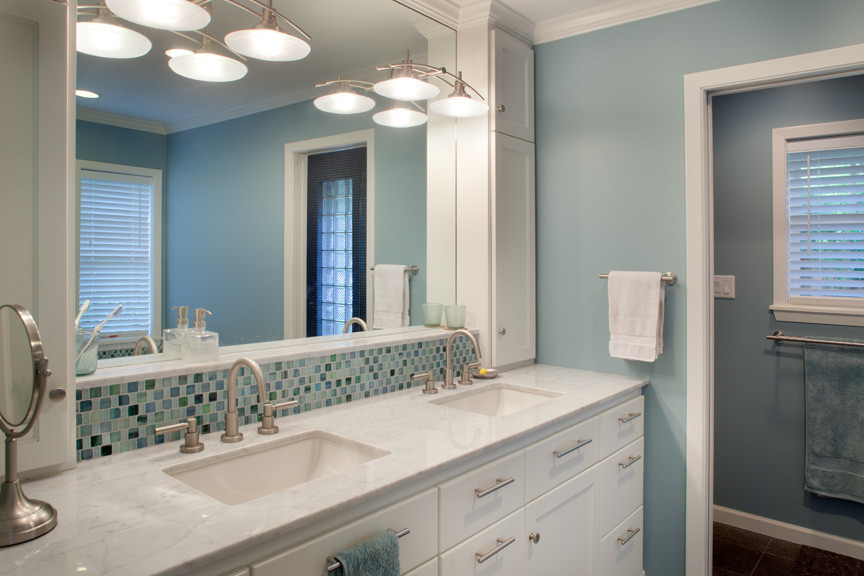 Photo of a mid-sized traditional master bathroom in Houston with an undermount sink, recessed-panel cabinets, white cabinets, marble benchtops, an alcove tub, a shower/bathtub combo, a two-piece toilet, blue tile, blue walls and ceramic floors.