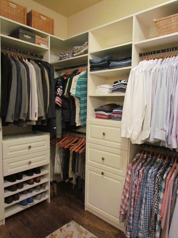 This is an example of a mid-sized traditional men's walk-in wardrobe in Atlanta with raised-panel cabinets, white cabinets and dark hardwood floors.