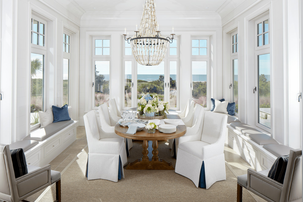Design ideas for a beach style dining room in Charleston with white walls and no fireplace.