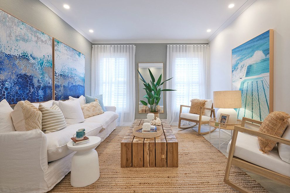 Beach style enclosed living room in Melbourne with grey walls, light hardwood floors and a corner fireplace.