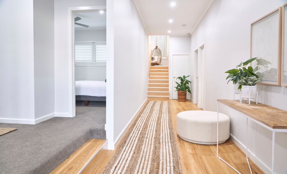 Small beach style hallway in Melbourne with white walls, carpet and grey floor.