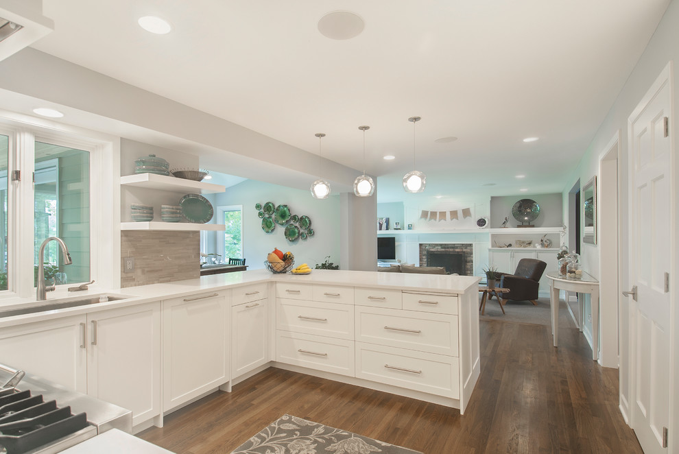 Inspiration for a large transitional galley open plan kitchen in Minneapolis with an undermount sink, shaker cabinets, white cabinets, multi-coloured splashback, matchstick tile splashback, stainless steel appliances, light hardwood floors and with island.