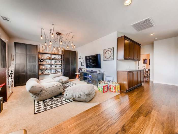 Photo of a large industrial gender-neutral kids' room in Dallas with grey walls, carpet and beige floor.