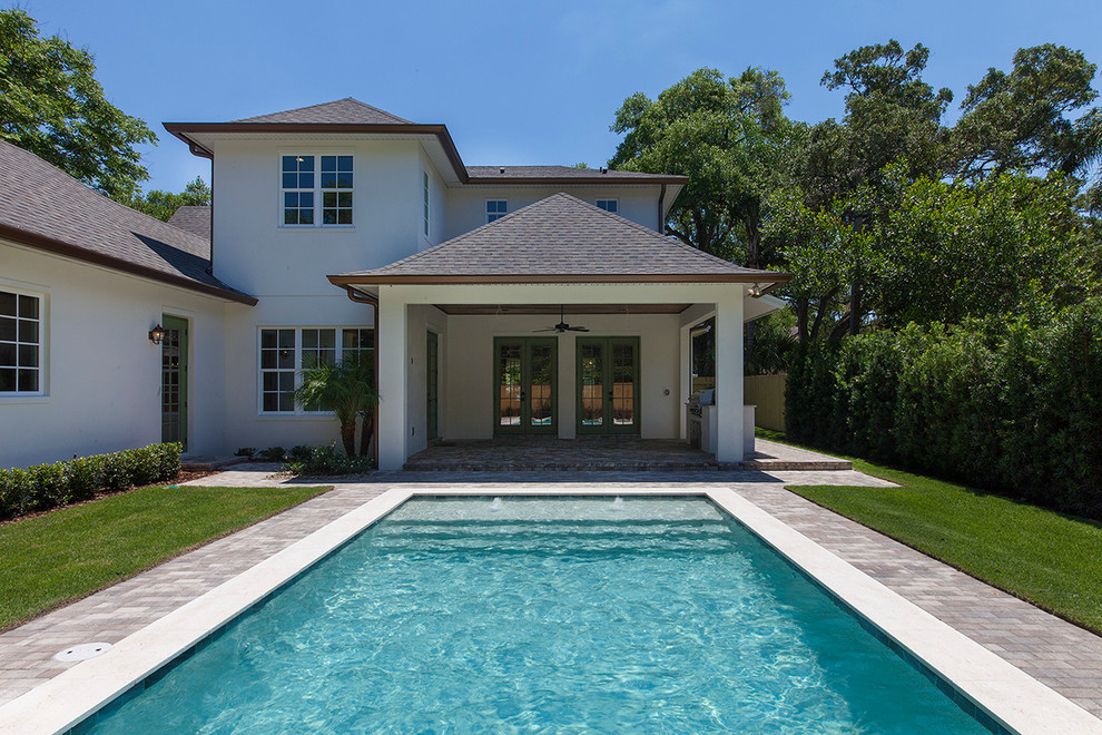 Pool fountain - large transitional backyard brick and rectangular pool fountain idea in Orlando