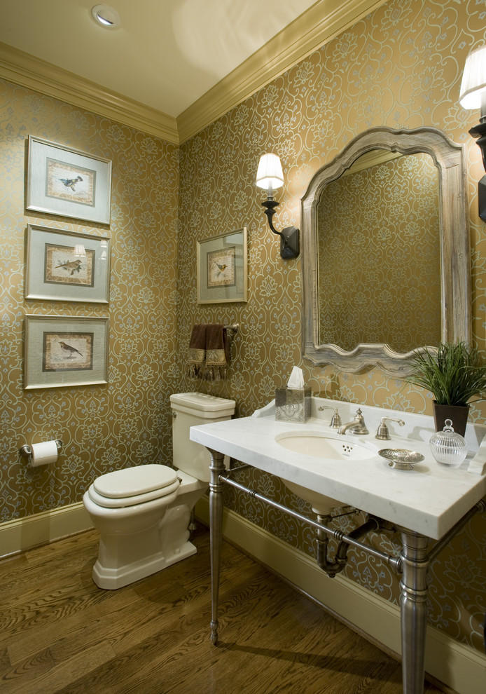 Design ideas for a traditional powder room in Philadelphia with an undermount sink and marble benchtops.