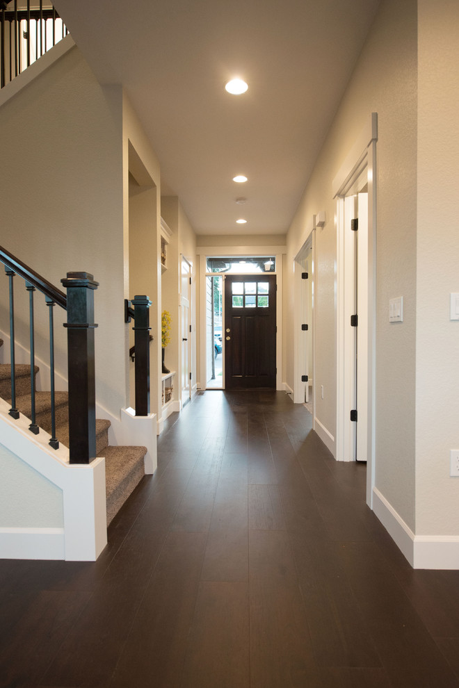 Design ideas for a mid-sized traditional foyer in Portland with beige walls, dark hardwood floors, a single front door and a white front door.