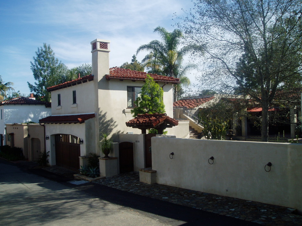 Photo of a mediterranean stucco white house exterior in San Diego with a tile roof.