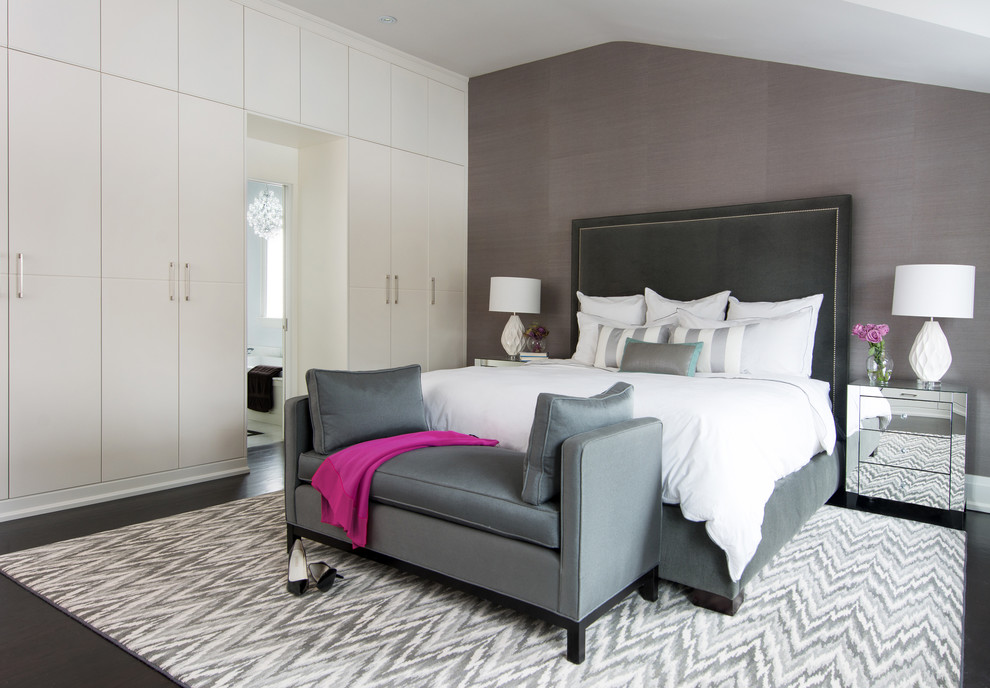 Large contemporary master bedroom in Toronto with grey walls and dark hardwood floors.