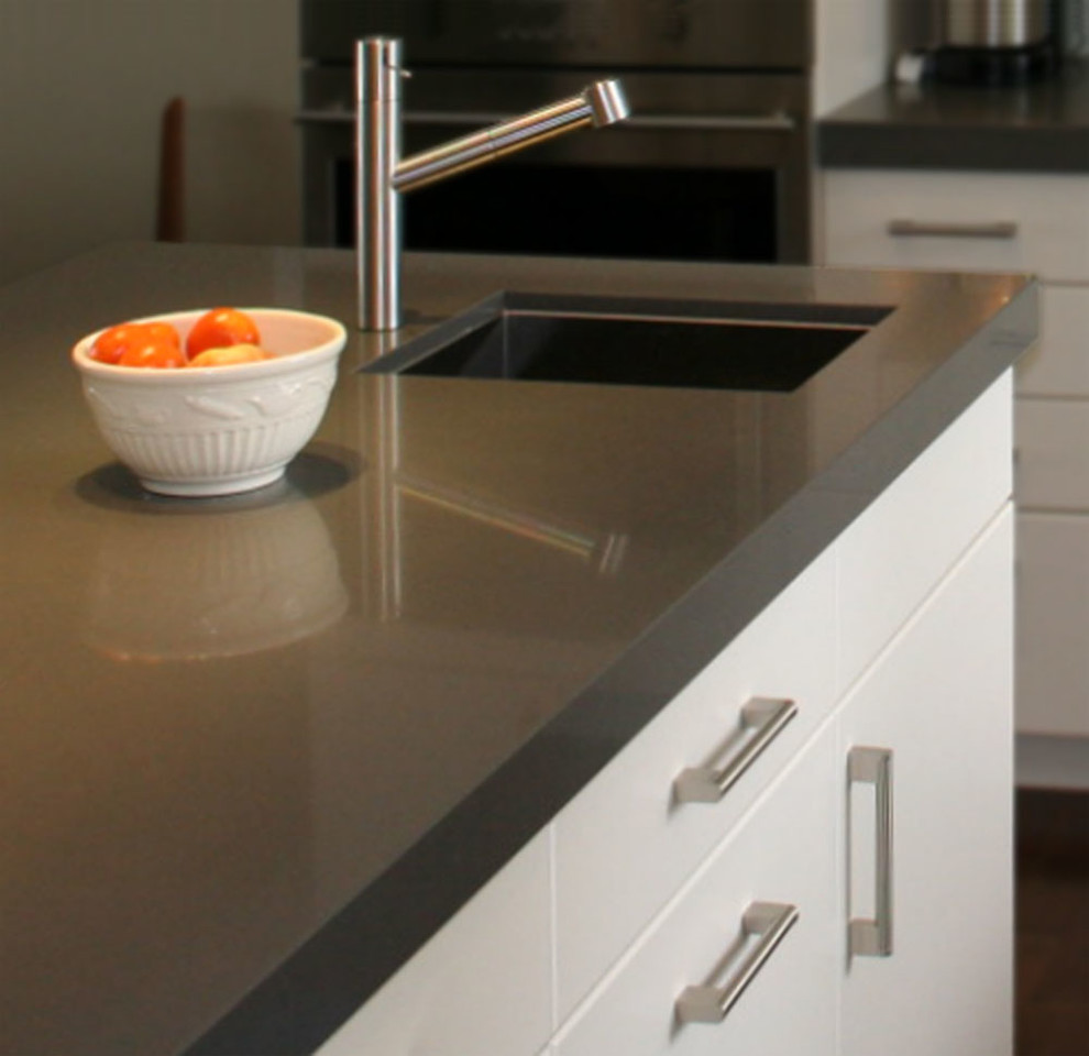 Open concept kitchen - mid-sized rustic l-shaped medium tone wood floor open concept kitchen idea in Toronto with an undermount sink, flat-panel cabinets, white cabinets, quartz countertops, white backsplash, glass tile backsplash, stainless steel appliances and two islands