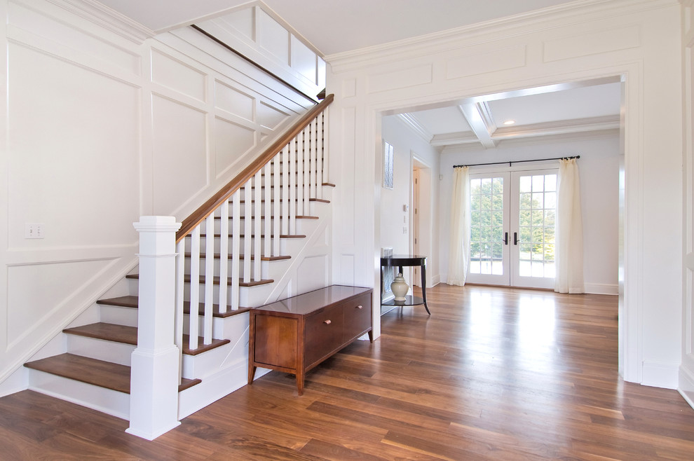 Inspiration for a traditional wood staircase in New York with wood railing.